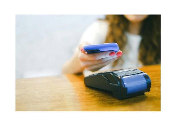 A woman is paying for a service using her mobile device